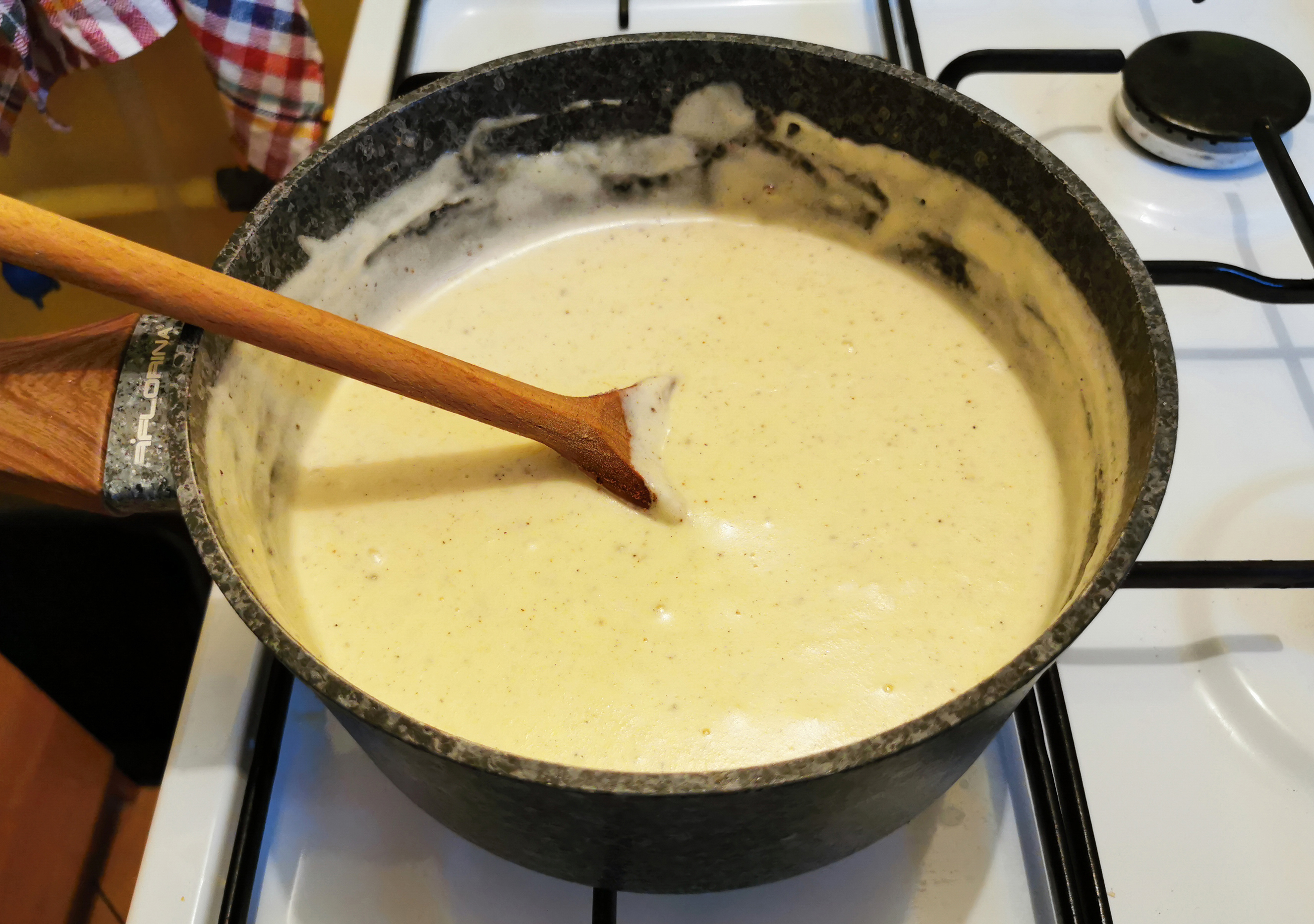 Pot of béchamel sauce being finished