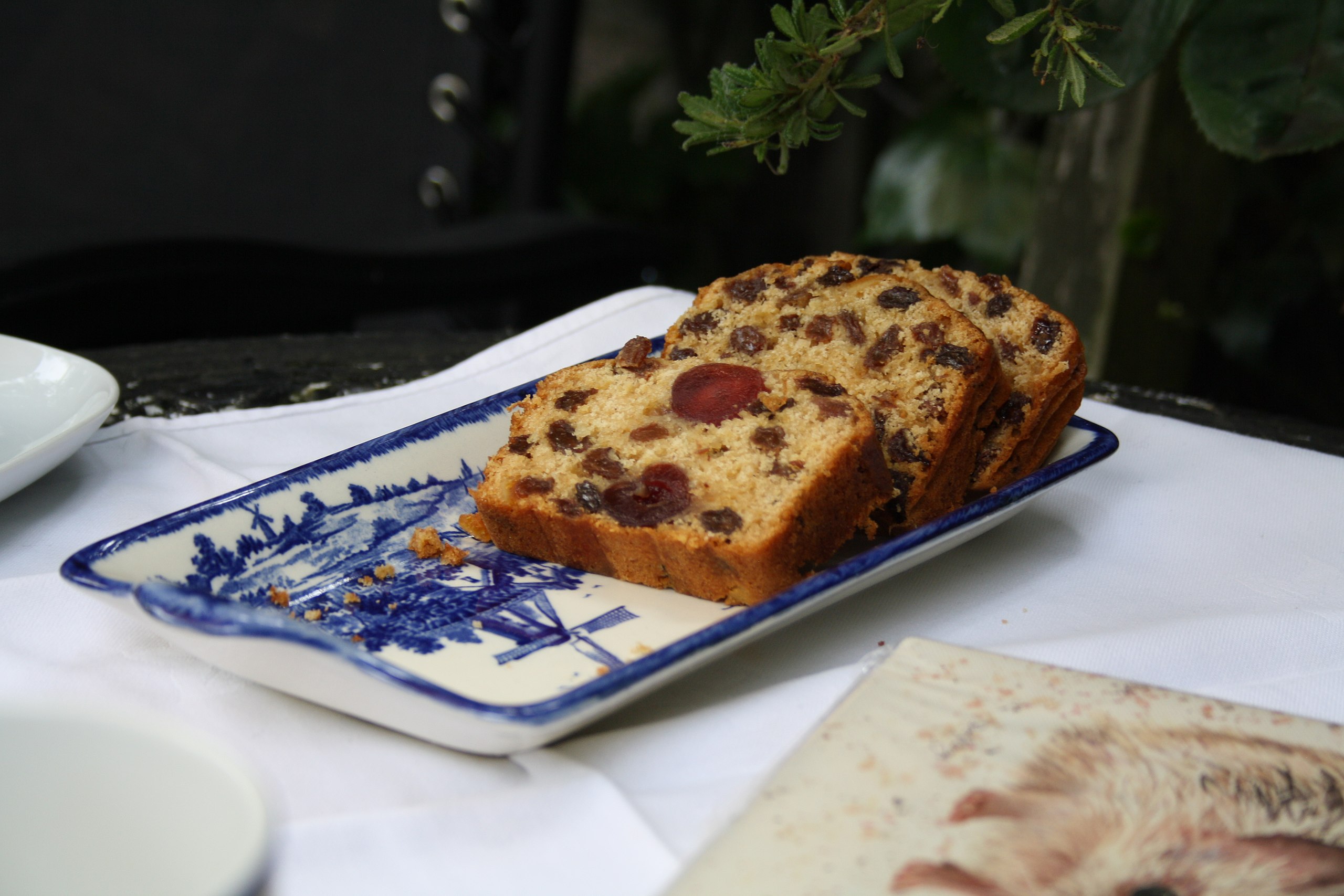 Sliced English Fruitcake, the inside of the cake shows the red cherries, sultanas and other dried fruit often inside a cake of this variety