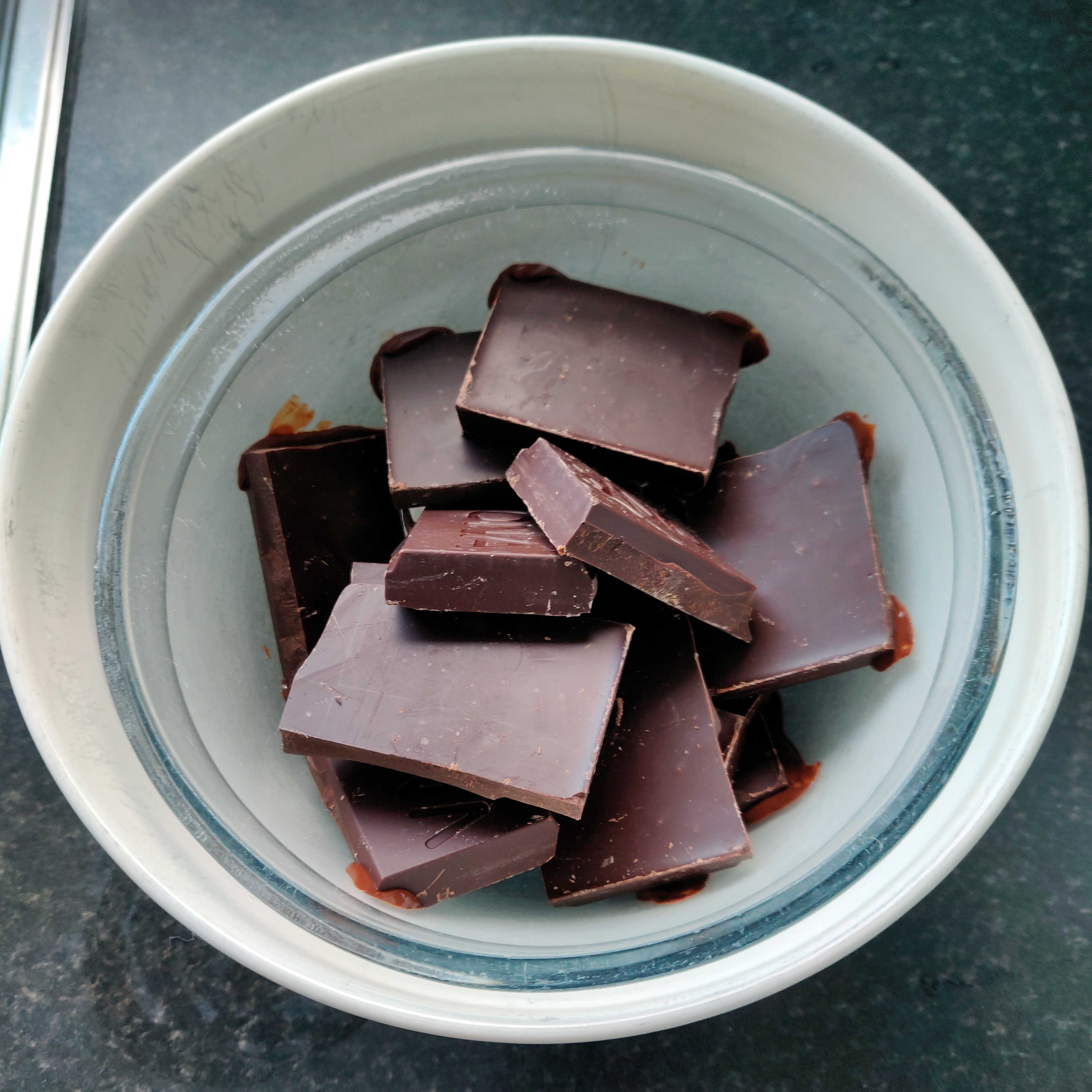 Broken chocolate set to melt in double bowl
